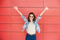 Joyful happy young woman jumping against red wall. Excited beautiful girl portrait Royalty Free Stock Photo