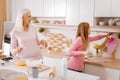 Joyful helpful girl taking an oven glove