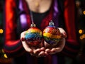 Joyful Holiday Spirit: Holding Rainbow-Colored Christmas Ornaments