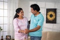 Joyful indian middle aged couple dancing together by holding hands at home - concept of Affectionate Bonding, Romantic Royalty Free Stock Photo