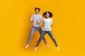 Joyful Interracial Couple Jumping In The Air And Showing Thumbs Up Royalty Free Stock Photo