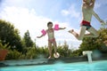 Joyful kids jumping to the swimming pool Royalty Free Stock Photo