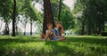 Joyful kids playing under tree. Smiling children have fun outdoors on weekend. Royalty Free Stock Photo