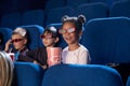 Joyful kids watching movie in 3D glasses, in cinema. Royalty Free Stock Photo