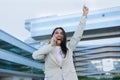 Joyful Latin Businesswoman Talking On Phone Shaking Raised Arms Outdoors Royalty Free Stock Photo