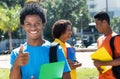 Joyful laughing african american male student showing thumb up w Royalty Free Stock Photo