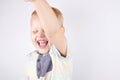 A joyful laughing three-year-old boy with a raised hand