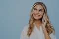 Joyful lightheaded blonde girl talking on phone Royalty Free Stock Photo