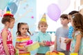 Joyful little kid boy receiving gifts at birthday party. Holidays, birthday concept. Royalty Free Stock Photo