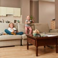 Joyful little children, boy and girl looking focused while playing video games using game controllers at home Royalty Free Stock Photo