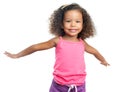 Joyful little girl with an afro hairstyle laughing with her arms extended