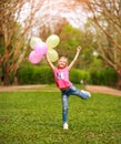 Joyful little girl child jumping from happiness in spring green park Royalty Free Stock Photo