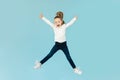 Joyful Little Girl Jumping Having Fun Posing, Blue Background Royalty Free Stock Photo