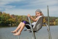 joyful little girl sitting and relaxing above the water in the life guard chair Royalty Free Stock Photo