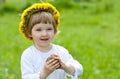 Joyful little girl in yellow chaplet Royalty Free Stock Photo