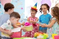 Joyful little kid girl receiving gifts at birthday party. Holidays, birthday concept. Royalty Free Stock Photo