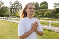 joyful long haired man in white