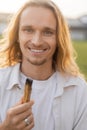 joyful long haired yoga man holding