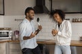 Happy young african american couple singing songs in kitchen. Royalty Free Stock Photo