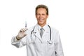 Joyful male doctor with syringe.