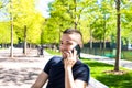 Joyful male having cellphone conversation during rest outdoors Royalty Free Stock Photo