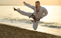 Joyful male practising karate kata poses Royalty Free Stock Photo