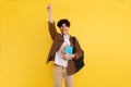 Joyful Male Student Gesturing Yes Posing On Yellow Studio Background