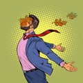 a joyful man in autumn maple leaves stands in the wind, opened his hands to the elements