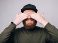 Joyful man is covering his own eyes with hands like he is waiting for a surprise. Royalty Free Stock Photo