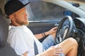 Joyful man driving car, using mobile phone with map gps navigationgoing Royalty Free Stock Photo