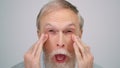 Joyful man grimacing in photo studio. Old guy making funny face indoors. Royalty Free Stock Photo