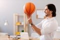 Joyful man holding basket ball