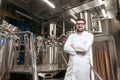 Joyful man posing with brewing mechanisms