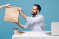 Joyful man in shirt work at desk with pc laptop isolated on blue background. Food products delivery courier service from