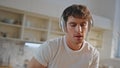 Joyful man singing cooking breakfast in headphones at home closeup. Guy dancing Royalty Free Stock Photo