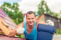 joyful man with a toolbox on the roof of the house during Royalty Free Stock Photo