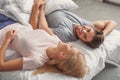 Joyful man and woman resting in bedroom Royalty Free Stock Photo