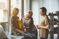 Joyful married couple spending time with surrogate pregnant woman