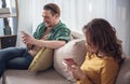 Joyful married couple using smartphones at home Royalty Free Stock Photo