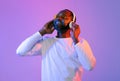 Joyful black man listening to music and smiling, using headphones Royalty Free Stock Photo