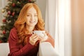 Joyful mature lady warming up with cup of tea Royalty Free Stock Photo