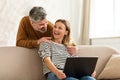 Joyful Middle Aged Spouses Using Laptop Browsing Internet At Home Royalty Free Stock Photo
