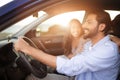 Joyful middle eastern couple in car on sunny trip