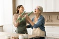 Joyful mom and excited adult daughter having fun in kitchen Royalty Free Stock Photo