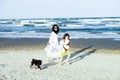 Joyful mom and son running on the beach with balloons Royalty Free Stock Photo