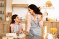 Joyful Mommy And Daughter Kid Holding Eggs Baking In Kitchen Royalty Free Stock Photo