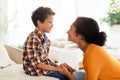 Joyful mother and son engaging in chat talking at home Royalty Free Stock Photo