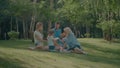 Joyful family picnicking in summer park