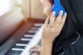 Joyful multiracial Asian woman musician in headphones playing piano keyboard at music studio. Royalty Free Stock Photo