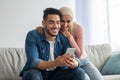 Joyful muslim couple watching photos on mobile phone Royalty Free Stock Photo